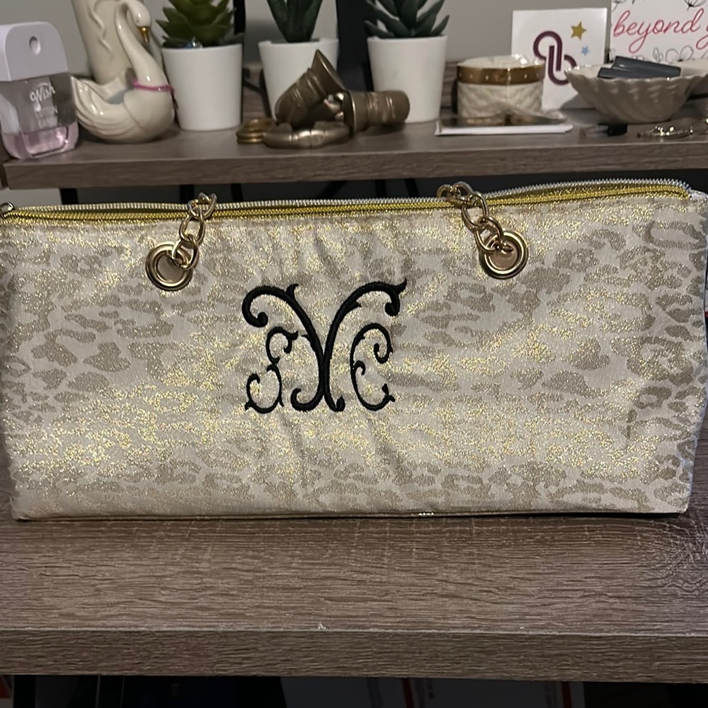 Elegant Gold and Cream Cosmetic Bag with Decorative Design insulated